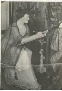 Portrait of Grace Drayton: Grace at her drawing table<BR> (undated photo courtesy of Janet Hays Austin).